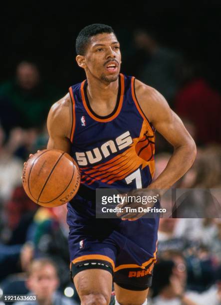 Kevin Johnson, Point Guard for the Phoenix Suns in motion dribbling the basketball down court during the NBA Midwest Division basketball game against...