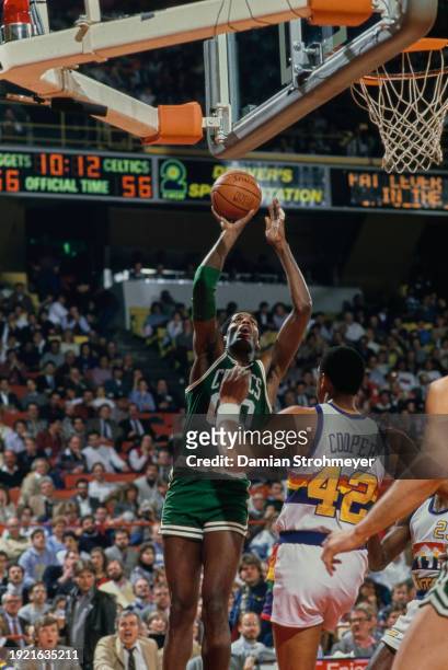 Robert Parish, Center for the Boston Celtics attempts a three point jump shot to the basket during the NBA Midwest Division basketball game against...