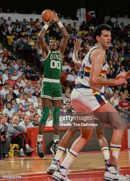 Robert Parish, Center for the Boston Celtics attempts a three point jump shot to the basket during the NBA Midwest Division basketball game against...