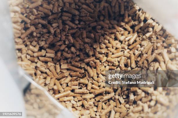 pellets in the biomass stove bag - multi fuel stoves stock pictures, royalty-free photos & images