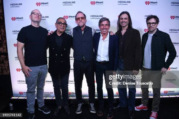 Patrick Wilson, Scott Shriner, Brian Bell and Rivers Cuomo of Weezer pose for a photo with Michael Kassan and Rich Bressler at a VIP dinner hosted by...