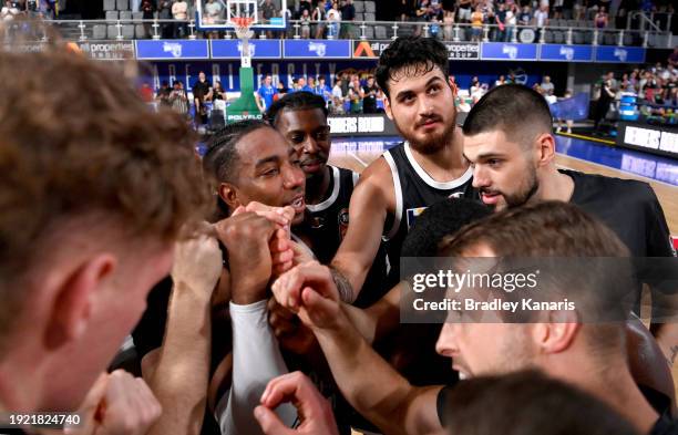 Chris Smith of the Bullets celebrates with his team mates after scoring a three point basket to win the match after the round 15 NBL match between...