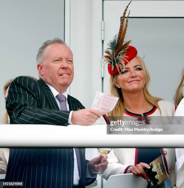 Doug Barrowman and Baroness Michelle Mone watch the racing as they attend day 4 'Gold Cup Day' of the Cheltenham Festival at Cheltenham Racecourse on...