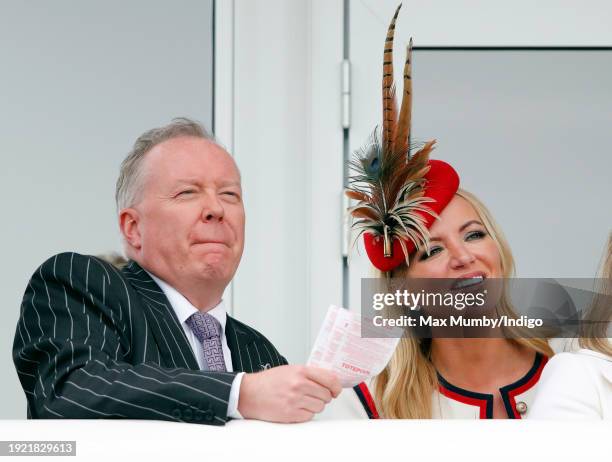 Doug Barrowman and Baroness Michelle Mone watch the racing as they attend day 4 'Gold Cup Day' of the Cheltenham Festival at Cheltenham Racecourse on...