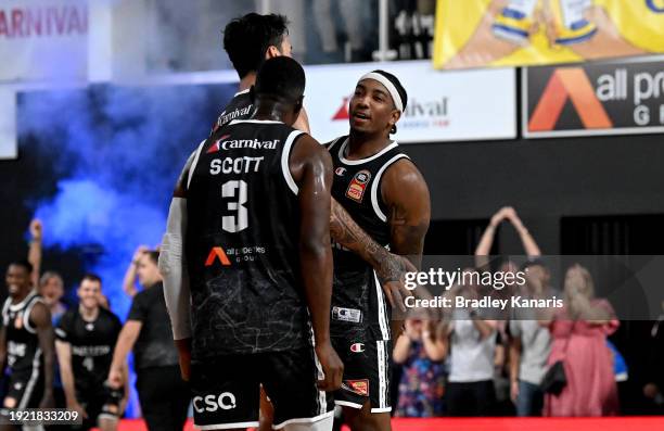 Chris Smith of the Bullets celebrates with his team mates after scoring a three point basket to win the match during the round 15 NBL match between...