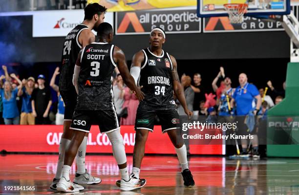 Chris Smith of the Bullets celebrates with his team mates after scoring a three point basket to win the match during the round 15 NBL match between...