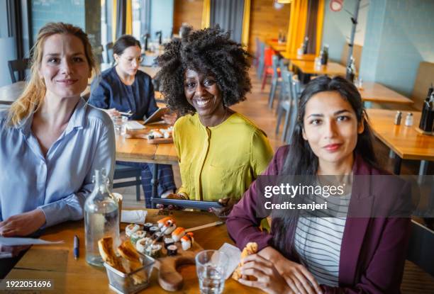 businesswomen having a lunch meeting - interest group stock pictures, royalty-free photos & images