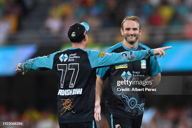 Paul Walter of the Heat celebrates with Matthew Renshaw during the BBL match between the Brisbane Heat and the Perth Scorchers at The Gabba, on...