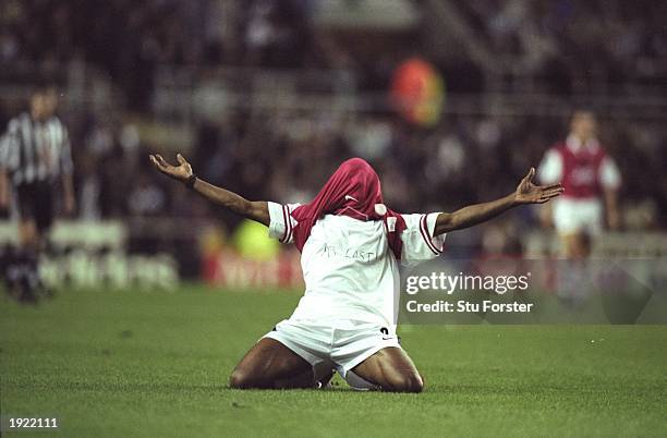 Ian Wright of Arsenal shows off the ''At Last'' written on his T-shirt after scoring the winning goal during an FA Carling Premiership match against...