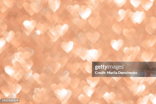 peach fuzz sparkling glitter hearts bokeh lights background - glitter fruit stock pictures, royalty-free photos & images