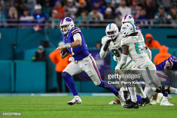Josh Allen of the Buffalo Bills runs the ball during an NFL football game against the Miami Dolphins at Hard Rock Stadium on January 7, 2024 in Miami...