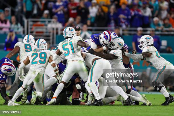 Josh Allen of the Buffalo Bills dives with the ball during an NFL football game against the Miami Dolphins at Hard Rock Stadium on January 7, 2024 in...