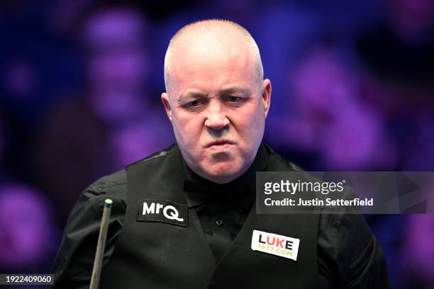 John Higgins of Scotland reacts during his first round match against Mark Allen of England on day four of the MrQ Masters Snooker 2024 at Alexandra...