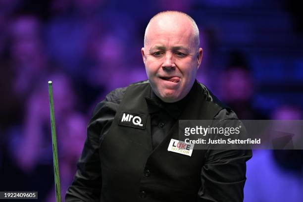 John Higgins of Scotland reacts during his first round match against Mark Allen of England on day four of the MrQ Masters Snooker 2024 at Alexandra...