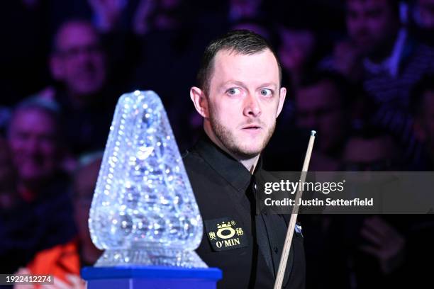 Mark Allen of England looks at the trophy as he enters the arena for his first round match against John Higgins of Scotland on day four of the MrQ...