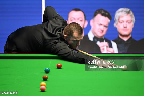 Mark Allen of England plays a shot during his first round match against John Higgins of Scotland on day four of the MrQ Masters Snooker 2024 at...