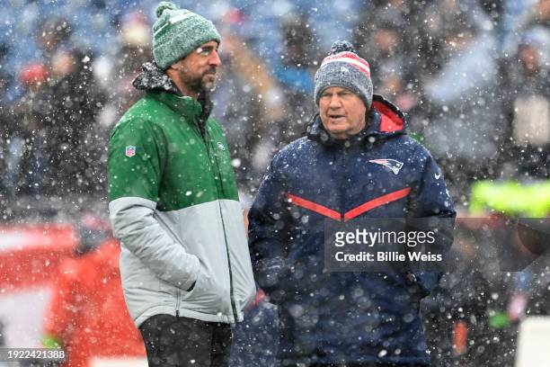 Head coach Bill Belichick of the New England Patriots talks with Aaron Rodgers of the New York Jets before the game at Gillette Stadium on January 7,...