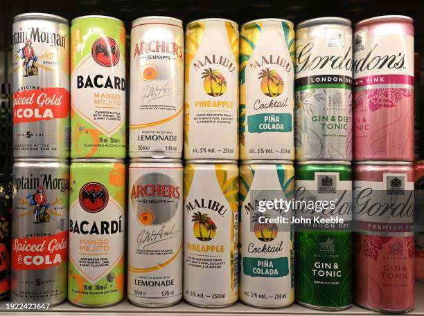 Various cans of alcoholic ready-to-drink beverages including Captain Morgan Rum and Coke, Bacardi MoJito, Archers and Lemonade, Malibu and Pineapple,...