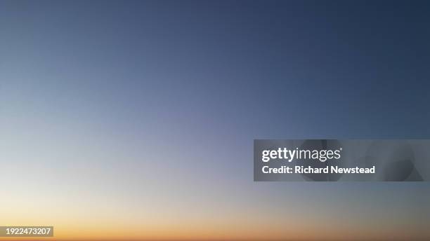 clear sky at sunset - evening sky orange stock pictures, royalty-free photos & images