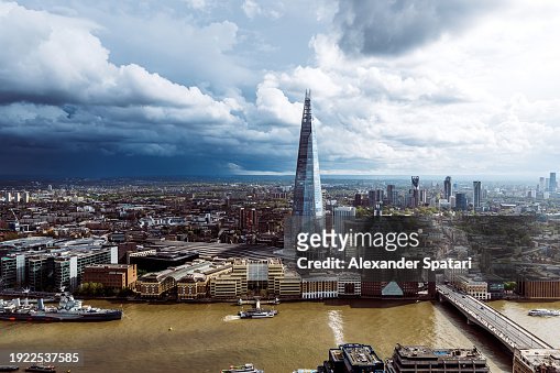 Aerial view of London cityscape with The Shard skyscraper on a cloudy day with dramatic sky, UK