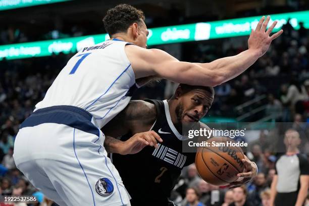 Xavier Tillman of the Memphis Grizzlies controls the ball as Dwight Powell of the Dallas Mavericks defends during the second half at American...