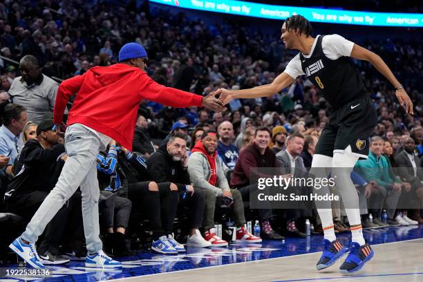 Ziaire Williams of the Memphis Grizzlies is congratulated by Tee Morant, father of Ja Morant of the Memphis Grizzlies, after making a 3-pt basket...