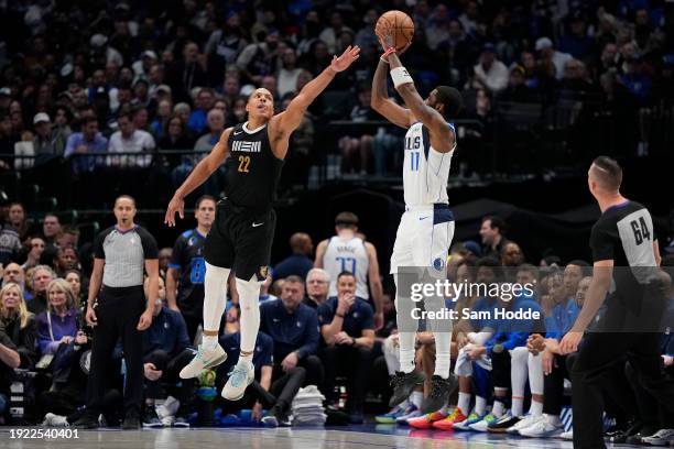 Kyrie Irving of the Dallas Mavericks shoots as Desmond Bane of the Memphis Grizzlies defends during the second half at American Airlines Center on...