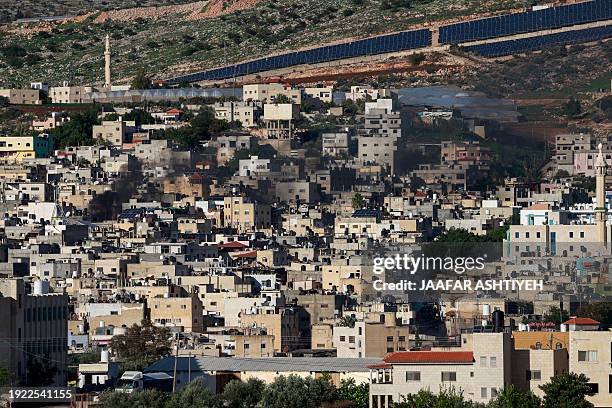 Black smoke billows amid clashes as Israeli forces raid the al-Faraa camp for Palestinian refugees near Tubas city in the occupied West Bank on...