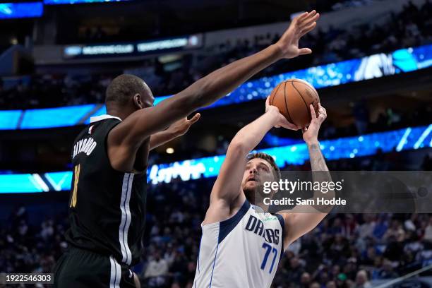 Luka Doncic of the Dallas Mavericks shoots as Bismack Biyombo of the Memphis Grizzlies defends during the first half at American Airlines Center on...