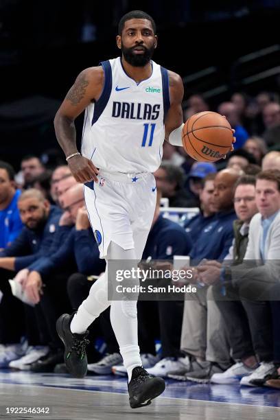 Kyrie Irving of the Dallas Mavericks brings the ball up court during the first half against the Memphis Grizzlies at American Airlines Center on...