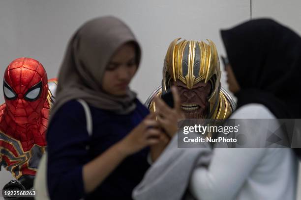 Two women are looking at a collection of action figures at a superhero-themed hangout called Iconic Arcade in Sleman, Yogyakarta, Indonesia, on...