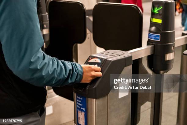 young boy paying with contactless wallet in the subway station of london. - train ticket stock pictures, royalty-free photos & images