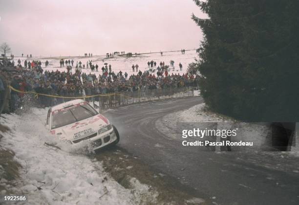 Tommi Makinen and Seppo Harjane of Finland slide off the road in their Mitsubishi Lancer during the Monte Carlo Rally in Monaco. Makinen and Harjane...