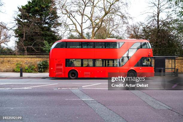 the famous red double decker bus in london in bus station. - red background stock pictures, royalty-free photos & images