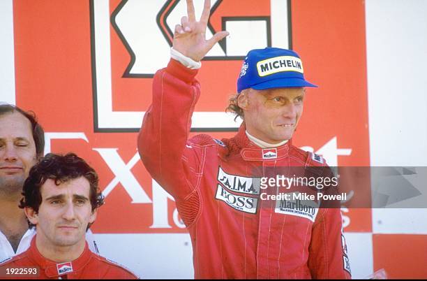 Marlboro McLaren drivers Alain Prost of France and Niki Lauda of Austria stand on the winners'' podium after the Portuguese Grand Prix at the Estoril...