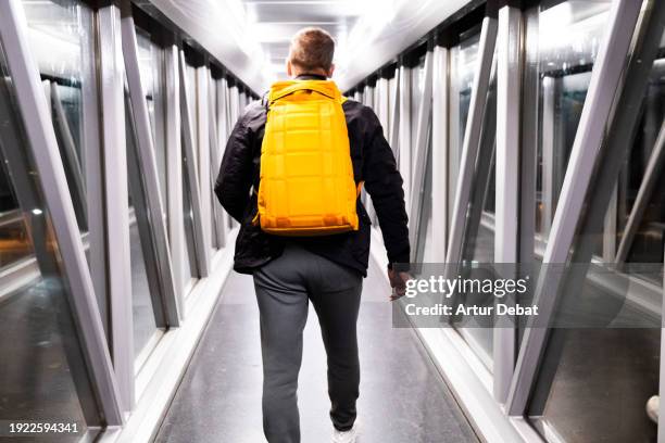 traveling at the airport finger with a cool backpack to a new destination. - priority boarding stock pictures, royalty-free photos & images