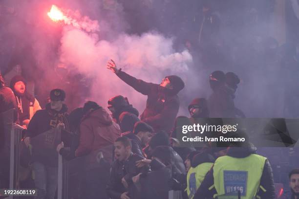 Smoke bombs and firecrackers are thrown between supporters of SS Lazio and AC Roma before the Coppa Italia quarter-finals match between SS Lazio and...