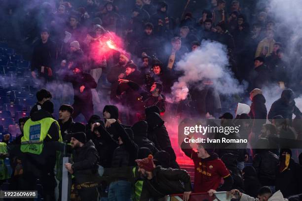 Smoke bombs and firecrackers are thrown between supporters of SS Lazio and AC Roma before the Coppa Italia quarter-finals match between SS Lazio and...