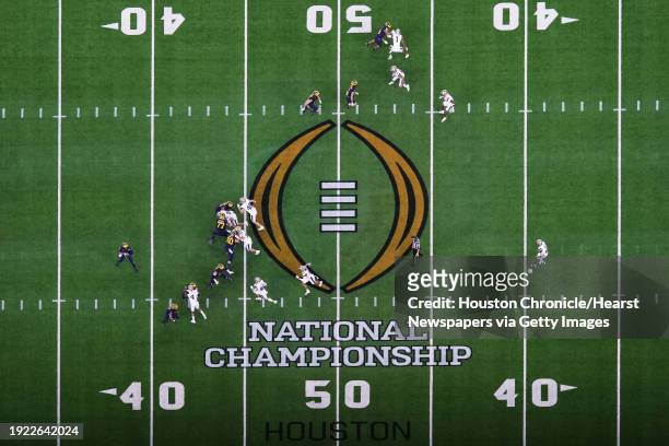 Michigan Wolverines quarterback J.J. McCarthy drops back to pass during the national championship NCAA College Football Playoff game at NRG Stadium,...