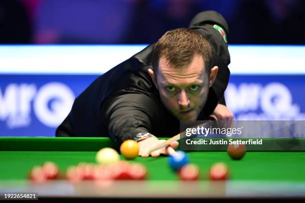 Mark Allen of England plays a shot during his first round match against John Higgins of Scotland on day four of the MrQ Masters Snooker 2024 at...