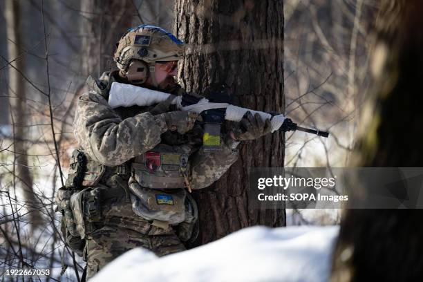 Ukrainian civilian performs the role of a sniper of an assault group during a military training. Training of Ukrainians who want to join the armed...