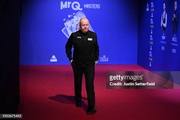 John Higgins of Scotland walks out after the interval during his first round match against Mark Allen of England on day four of the MrQ Masters...