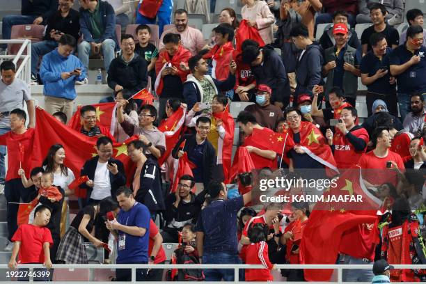 China's supporters react during the Qatar 2023 AFC Asian Cup Group A football match between China and Tajikistan at the Abdullah bin Khalifa Stadium...
