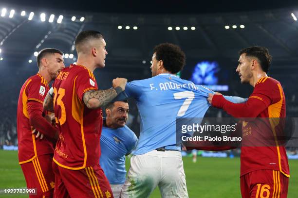 Felipe Anderson of SS Lazio is held back by Gianluca Mancini of AS Roma and Leandro Paredes of AS Roma during the Coppa Italia match between SS Lazio...