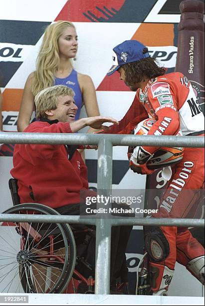 Marlboro Team boss Wayne Rainey of the USA joins Yamaha rider Loris Capirossi of Italy on the 500cc winners'' podium after the Australian Grand Prix...