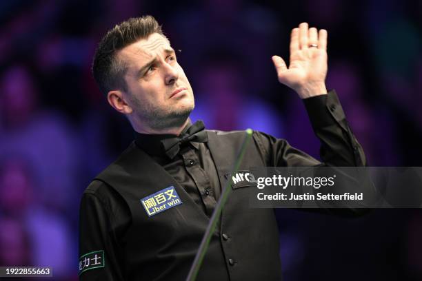 Mark Selby of England swats an insect in his first round match against Robert Milkins of England during day four of the MrQ Masters Snooker 2024 at...