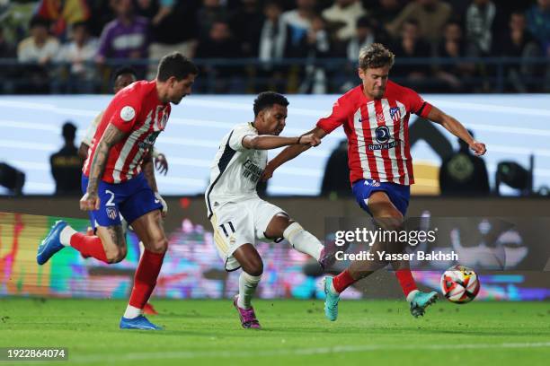 Rodrygo of Real Madrid shoots under pressure from Marcos Llorente of Atletico Madrid during the Super Copa de Espana semi-final match between Real...