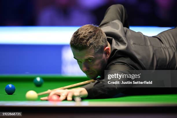 Mark Selby of England plays a shot in his first round match against Robert Milkins of England during day four of the MrQ Masters Snooker 2024 at...