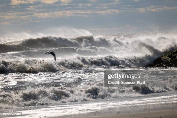 Large waves crash along the beach at Rockaway during heavy surf following a storm that brought high winds and rain to the area on January 10, 2024 in...