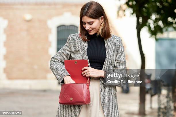woman looking in her bag in the street - street fashion stock pictures, royalty-free photos & images